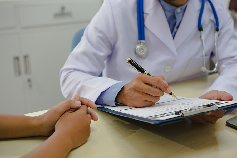 A photo of a doctor reviewing a chart with a patient.